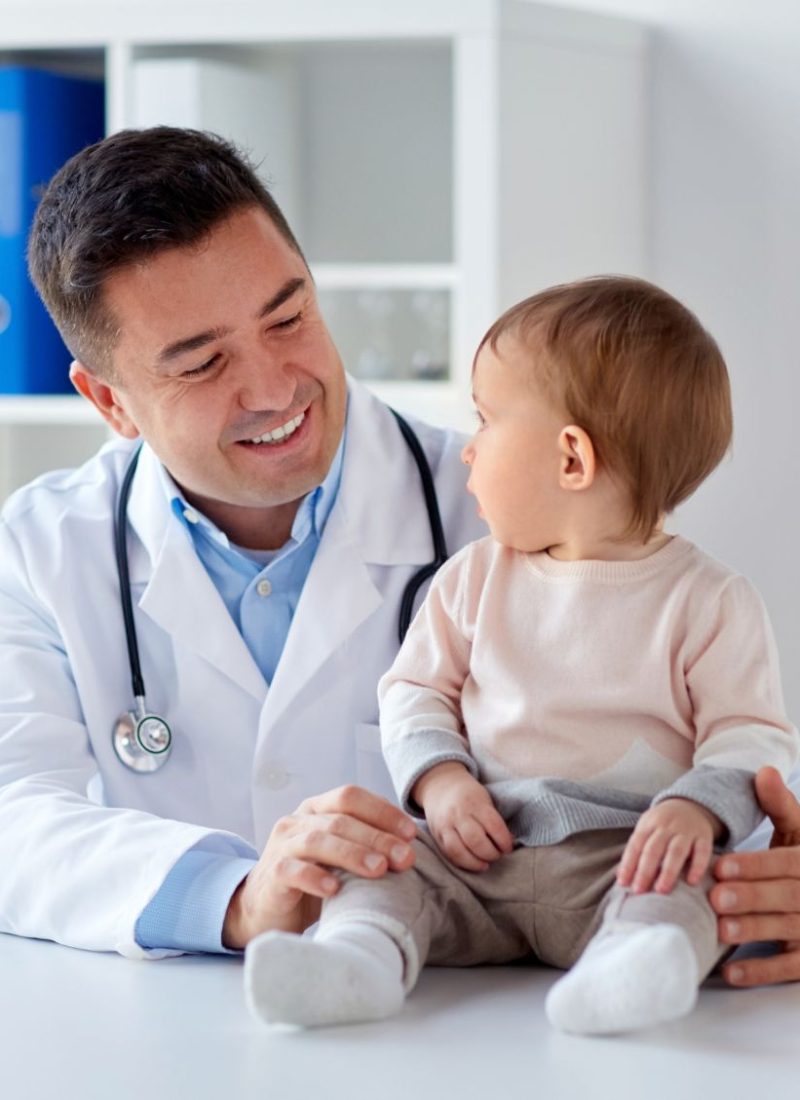 happy-doctor-or-pediatrician-with-baby-at-clinic-PXZU778-1-1.jpg